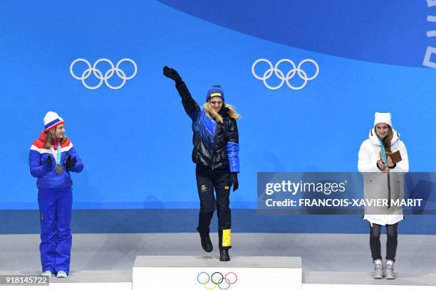 Norway's silver medallist Maiken Caspersen Falla, Sweden's gold medallist Stina Nilsson and Russia's bronze medallist Yulia Belorukova pose on the...