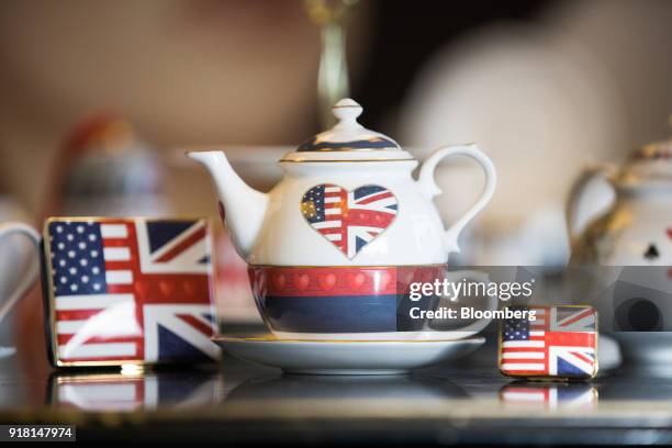 China teapot, centre, and enamel trinket cases made to commemorate the wedding between Henry Windsor and Meghan Markle stand on display at Halcyon...