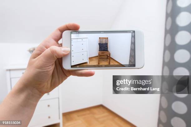 mobile phone displaying chair in room - augmented reality stock pictures, royalty-free photos & images