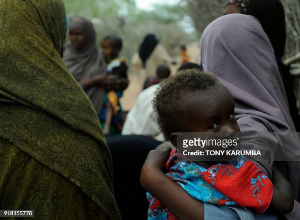 Young Somali refugee waits with her mother to be vaccinated at a paediatric vaccination centre at Hagadere refugee site within the Dadaab refugee...