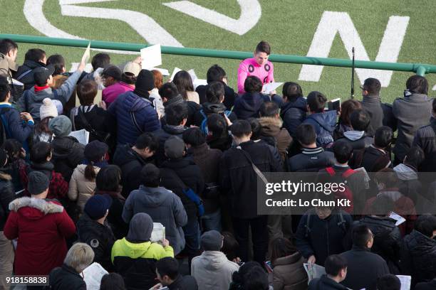 Jockey Cristian Demuro gives his autograph to Japanese racing fans at Nakayama Racecourse on December 28, 2014 in Funabashi, Chiba, Japan.