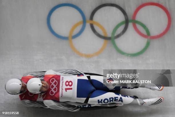 South Korea's Park Jinyong and Cho Jung Myung compete in the doubles luge run 1 during the Pyeongchang 2018 Winter Olympic Games at the Olympic...