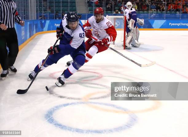 Tomas Surovy of Slovakia controls the puck against Mikhail Grigorenko of Olympic Athlete from Russia in the second period during the Men's Ice Hockey...