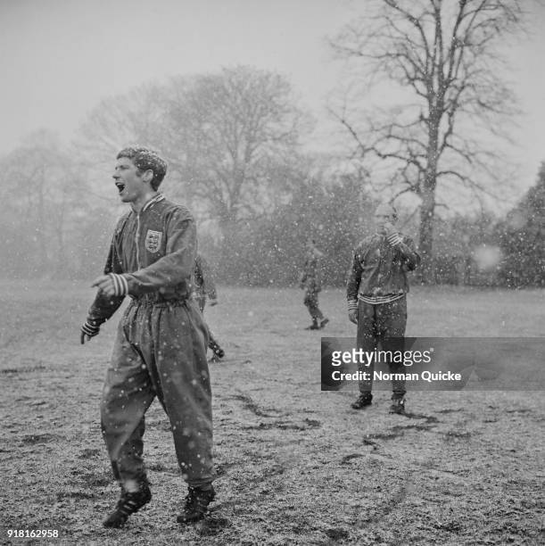 British soccer player Alan Ball Jr training under the snow with the England team, under the supervision of soccer manager Alf Ramsey , UK, 3rd April...