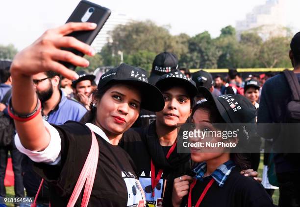 Volunteers take selfies during an event to mark International Condom Day in New Delhi on February 13, 2018. The event was organised by AIDS...