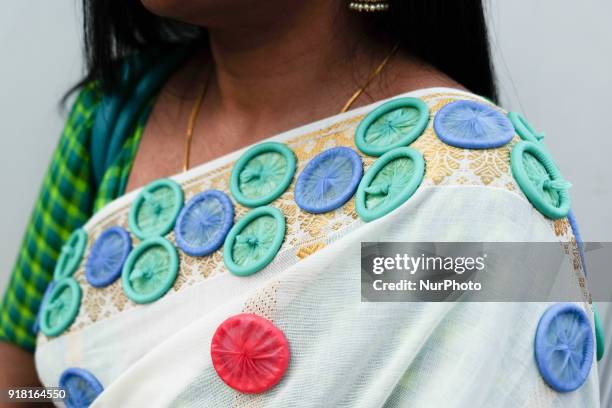 Woman wears a sari designed with condoms during an event to mark International Condom Day in New Delhi on February 13, 2018. The event was organised...