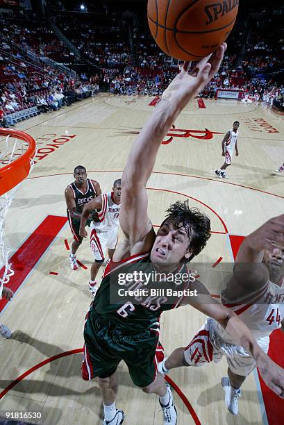 Andrew Bogut of the Milwaukee Bucks shoots the ball over Chuck Hayes of the Houston Rockets on October 12, 2009 at the Toyota Center in Houston,...