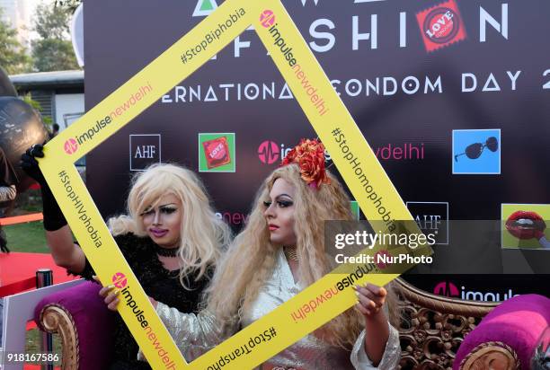 Local drag artists pose at the selfie booth during an event to mark International Condom Day in New Delhi on February 13, 2018. The event was...