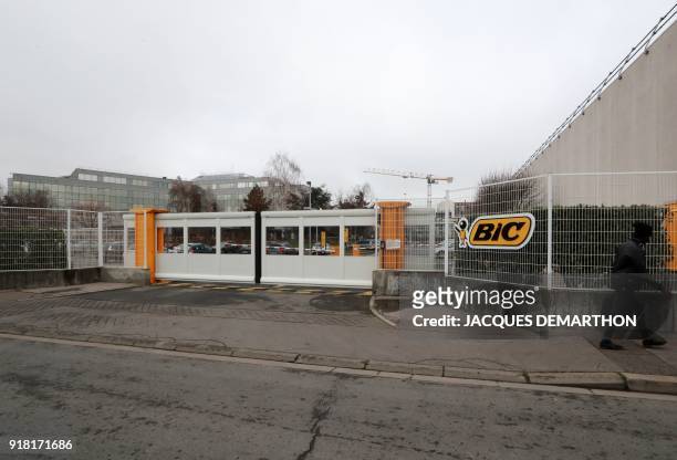 Man walks in front of the headquarters of Bic, French maker of lighters, pens and razors, in Clichy, near Paris, on February 14, 2018. The company's...