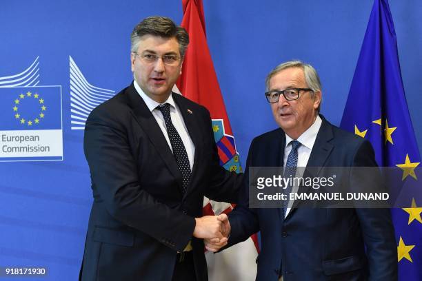 European Commission President Jean-Claude Juncker welcomes and shake hands with Croatian Prime Minister Andrej Plenkovic ahead of a meeting at the...