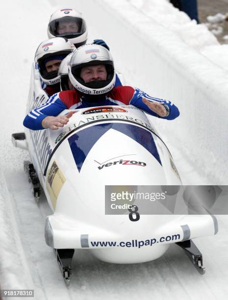 The Russia-1 Bobsleigh team driven by Alexandr Zoubkov crosses the finish line at the end of the fourth and final heat in third place overall in the...