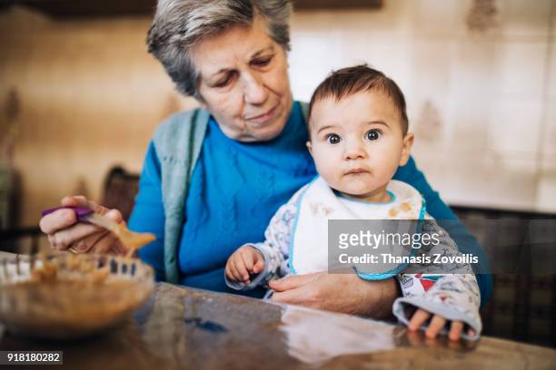 grandmother with her grandson - feeding bildbanksfoton och bilder