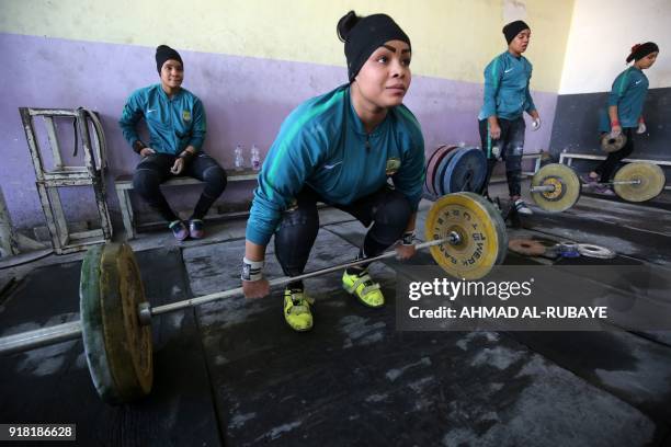 Year-old Iraqi weightlifter Huda Salim Al-Saedi trains on January 18, 2018 at a club in Sadr City, east of Baghdad. The weightlifters on Iraq's...