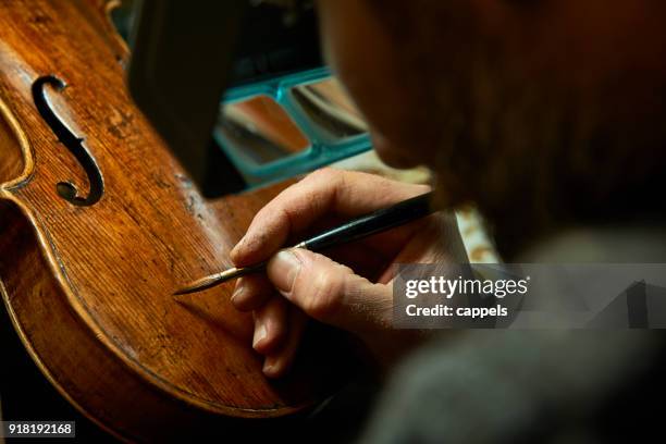 the violin restorer. - musical instrument repair stock pictures, royalty-free photos & images