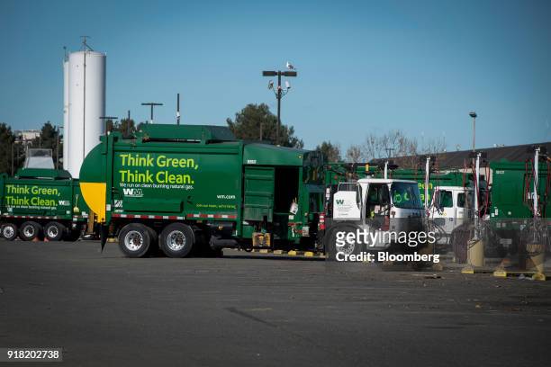 Waste Management Inc. Garbage collection trucks sit parked at a service center in San Leandro, California, U.S., on Monday, Feb. 12, 2018. Waste...