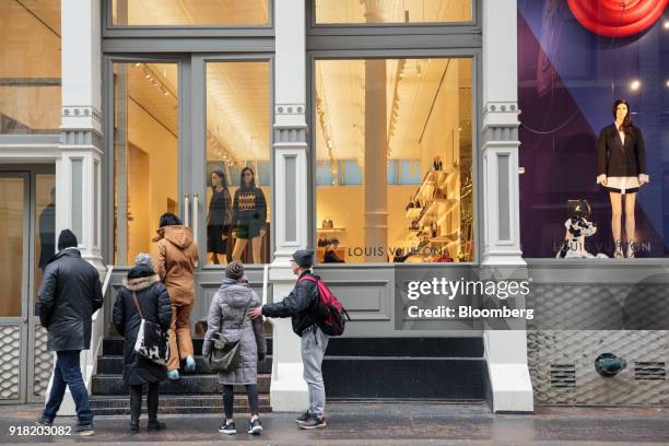 Shoppers enter a LVMH Moet Hennessy Louis Vuitton SE store in the SoHo neighborhood of New York, U.S., on Friday, Feb. 9, 2018. Bloomberg is...