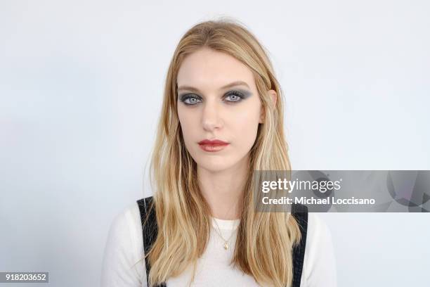 Model prepares backstage for Laquan Smith during New York Fashion Week: The Shows at Gallery I at Spring Studios on February 14, 2018 in New York...