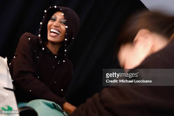 Model prepares backstage for Laquan Smith during New York Fashion Week: The Shows at Gallery I at Spring Studios on February 14, 2018 in New York...