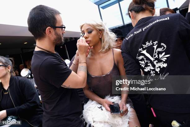 Model prepares backstage for Laquan Smith during New York Fashion Week: The Shows at Gallery I at Spring Studios on February 14, 2018 in New York...