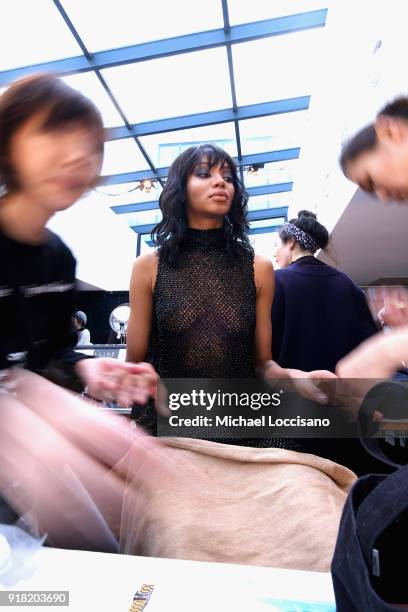 Model prepares backstage for Laquan Smith during New York Fashion Week: The Shows at Gallery I at Spring Studios on February 14, 2018 in New York...