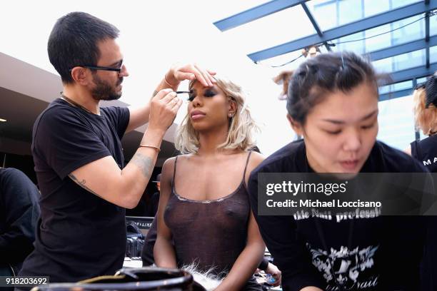 Model prepares backstage for Laquan Smith during New York Fashion Week: The Shows at Gallery I at Spring Studios on February 14, 2018 in New York...