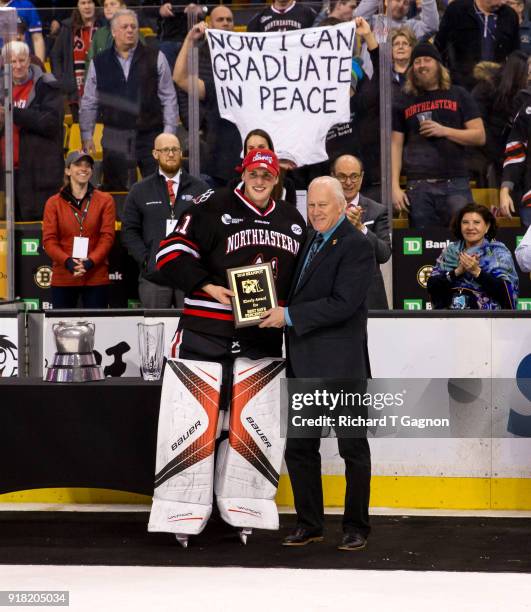 Cayden Primeau of the Northeastern Huskies accepts the Eberly Award from Dan Eberly after a game against the Boston University Terriers during NCAA...