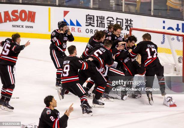 Cayden Primeau of the Northeastern Huskies celebrates with teammates Biagio Lerario, Eric Williams, Adam Gaudette and Matt Filipe after a victory...