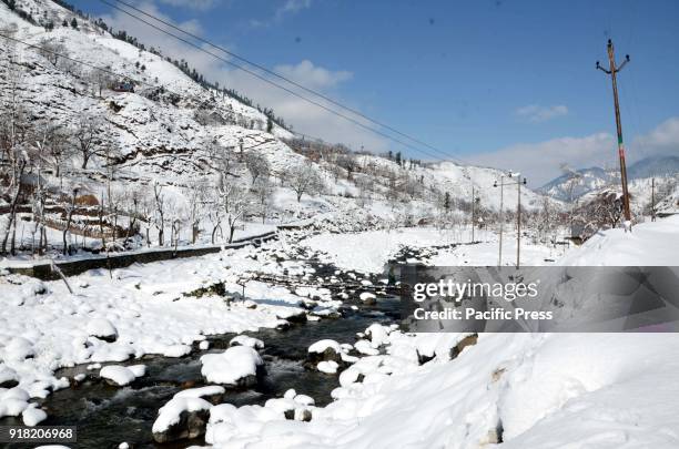 People walking on a footbridge over a stream in Daksum, about 97 kilometers south of Srinagar city, the summer capital of Indian-controlled Kashmir,...