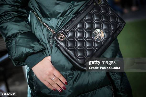 Ana Ruano wears Asos shoes, Zara trousers and coat, Kate Spade handbag and Ray-Ban sunglasses on February 11, 2018 in Madrid, Spain.