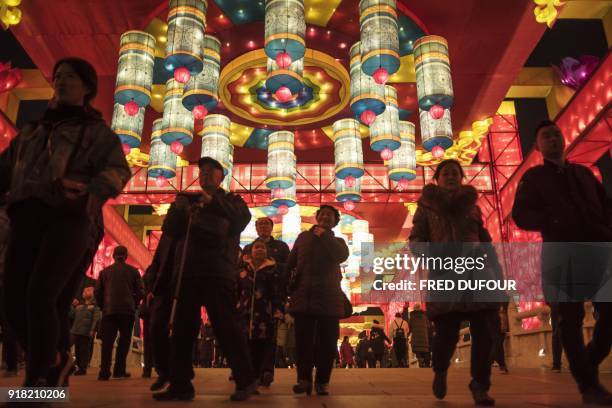 Chinese people take pictures of lanterns and decorations at the Tang Paradise Park in Xian, Shaanxi province, on February 14 ahead of the coming...