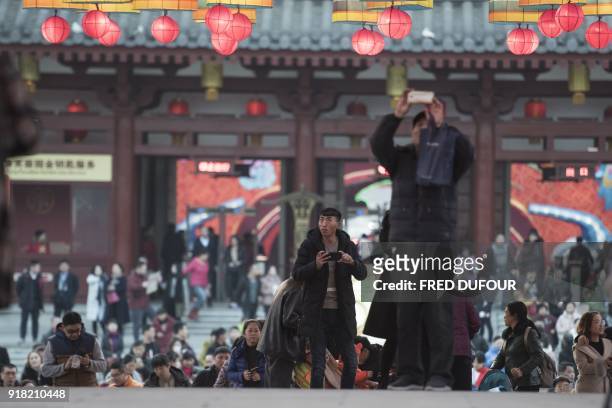 Chinese people take pictures of lanterns at the Tang Paradise Park in Xian, Shaanxi province, on February 14 ahead of the coming Lunar New Year,...