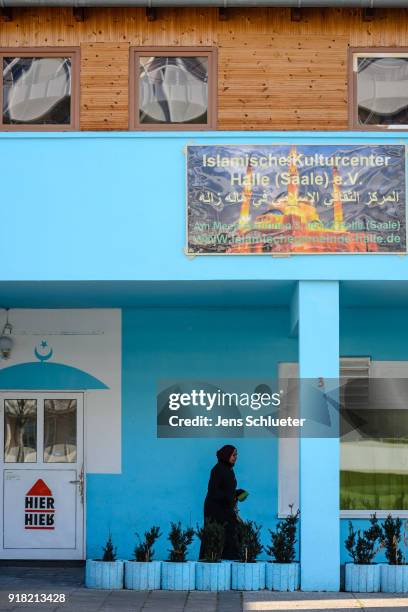 Muslim woman walks along the Muslim cultural center and mosque following a recent attack just before the beginning of the visit of Aydan Ozoguz ,...