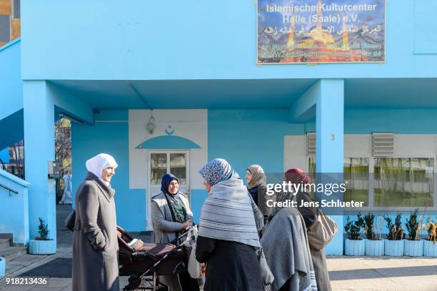 Muslim women stand in front of the Muslim cultural center and mosque following a recent attack just before the beginning of the visit of Aydan Ozoguz...