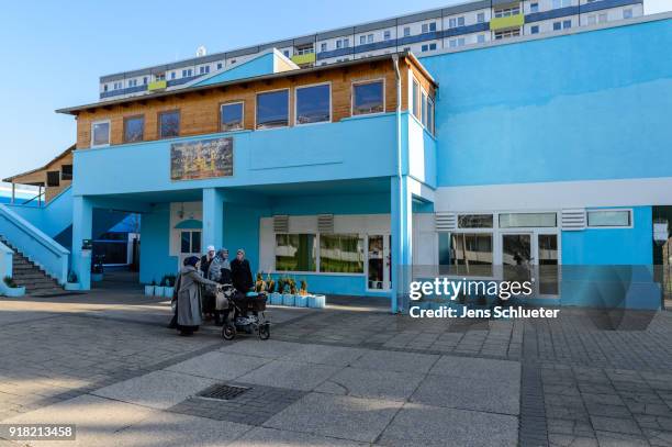 Muslim women walk along the Muslim cultural center and mosque following a recent attack just before the beginning of the visit of Aydan Ozoguz ,...