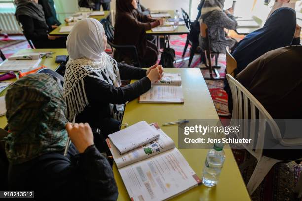 Muslim women from Syria take part in a German lesson in the Muslim cultural center and mosque as Aydan Ozoguz , German Federal Commissioner for...