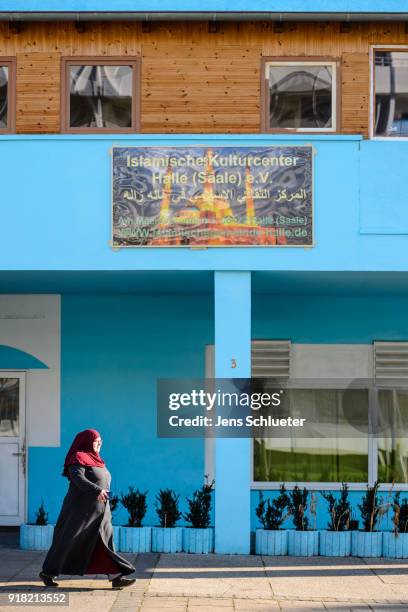 Muslim woman walks along the Muslim cultural center and mosque following a recent attack just before the beginning of the visit of Aydan Ozoguz ,...