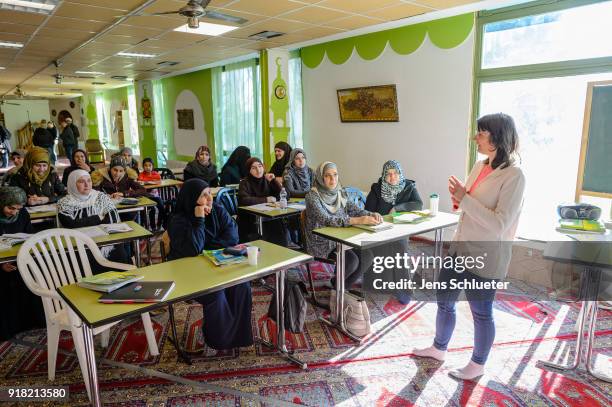 Muslim women from Syria take part in a German lesson in the Muslim cultural center and mosque as Aydan Ozoguz , German Federal Commissioner for...