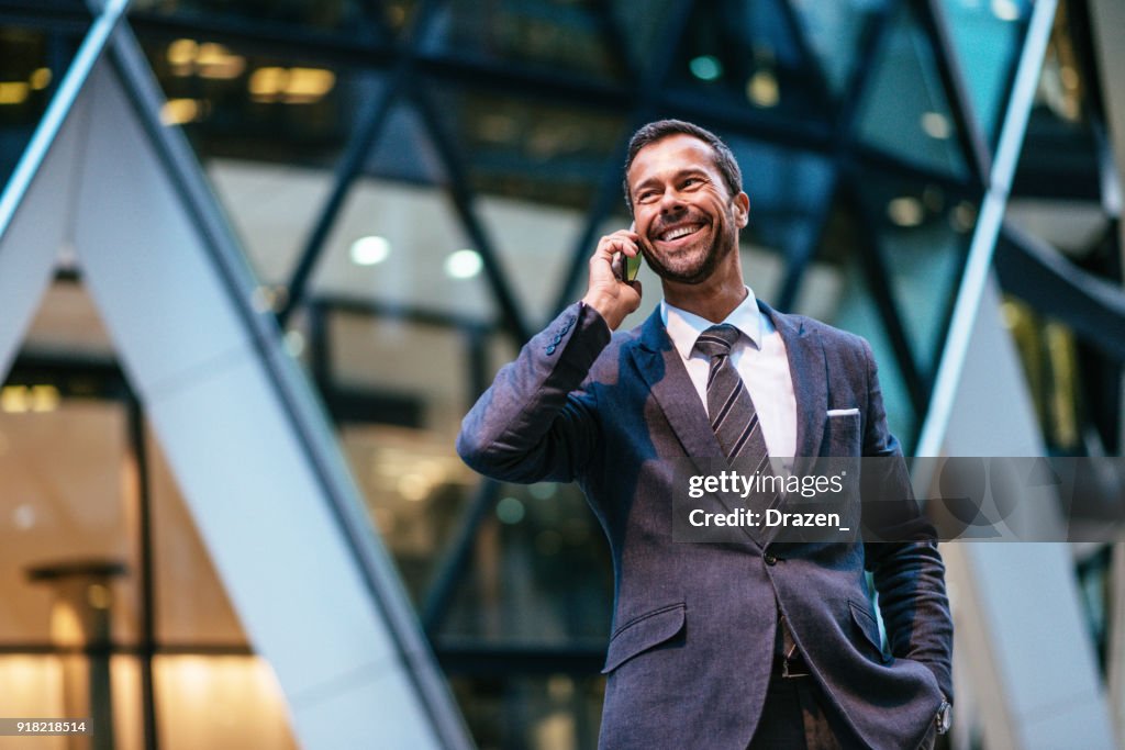 Portrait of mature business person with mobile phone