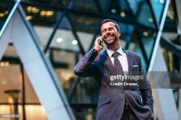 portrait of mature business person with mobile phone - deal england stock pictures, royalty-free photos & images