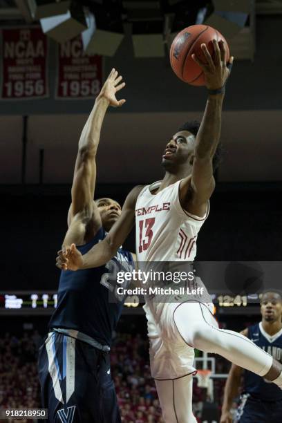 Quinton Rose of the Temple Owls attempts a shot against Jermaine Samuels of the Villanova Wildcats at the Liacouras Center on December 13, 2017 in...