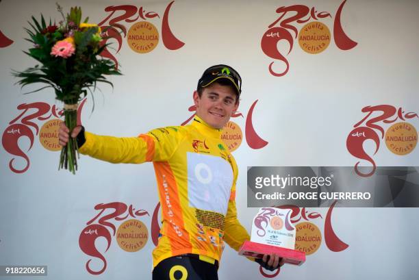Direct Energie's French cyclist Thomas Boudat sports the leader's yellow jersey as he celebrates on the podium winning the first stage of the "Ruta...