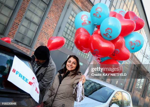 Supporters of German-Turkish journalist Deniz Yucel demonstrate with heart-shaped balloons during a motorcade protest on February 14, 2018 in Berlin,...