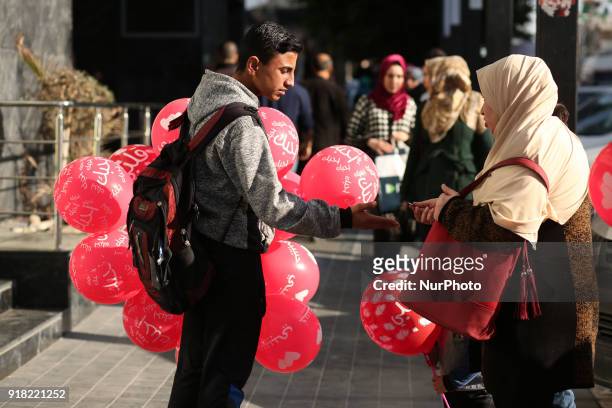 Palestinian youth sells balloons on Valentine's Day in Gaza City on February 14, 2018.