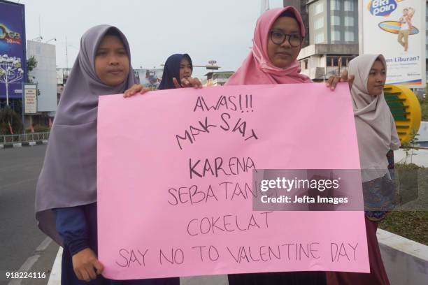 Indonesian muslim students holds a banners during an anti-Valentine protest in Banda Aceh, Indonesia, on February 14, 2018. Islamic conservatives in...