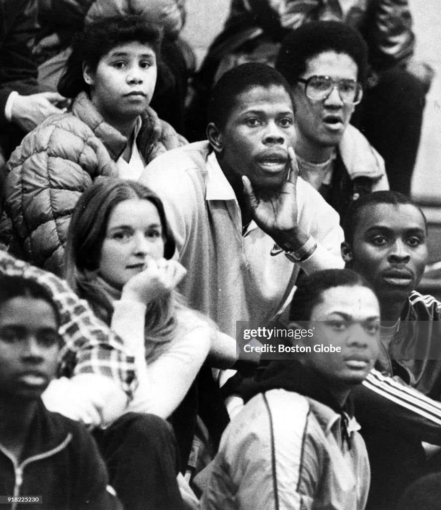 Patrick Ewing sits in the crowds during a game between Brookline and
