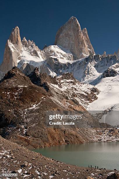 hikers dwarfed by fitz roy - chalten stock pictures, royalty-free photos & images
