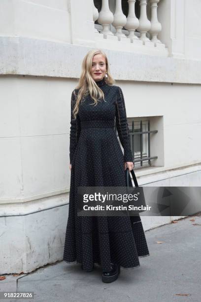 Stylist and creative consultant, Kate Foley Osterweis wears a Valentino dress, Sonia Boyajian earrings, Staud bag and Sacai shoes day 6 of Paris...
