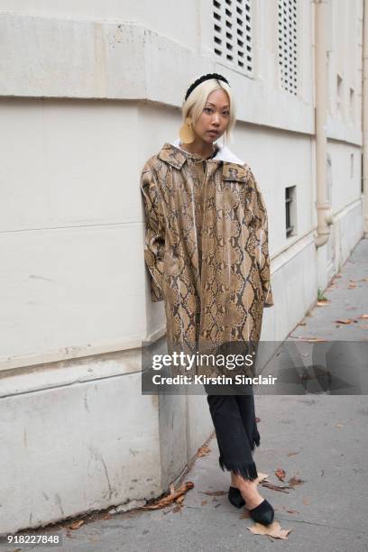Fashion blogger Vanessa Hong of The Haute Pursuit wears a Valentino coat, Frame denim jeans, Chanel shoes, Paula Mendoza earrings and Altuzarra...