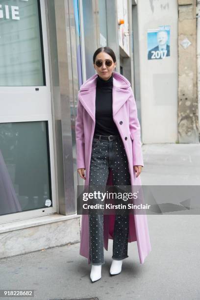 Digital Director at Vogue Korea Jiyoung Kim wears a Valentino coat, Isabel Marant jeans, Balenciaga boots and Le Specs sunglasses day 6 of Paris...