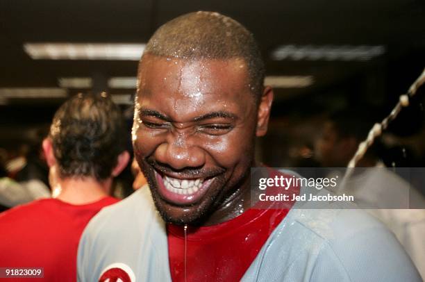 Ryan Howard of the Philadelphia Phillies laughs as he enjoys a champagne shower while celebrating the victory against the Colorado Rockies in Game...